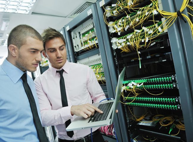 group of young business people it engineer in network server room solving problems and give help and support